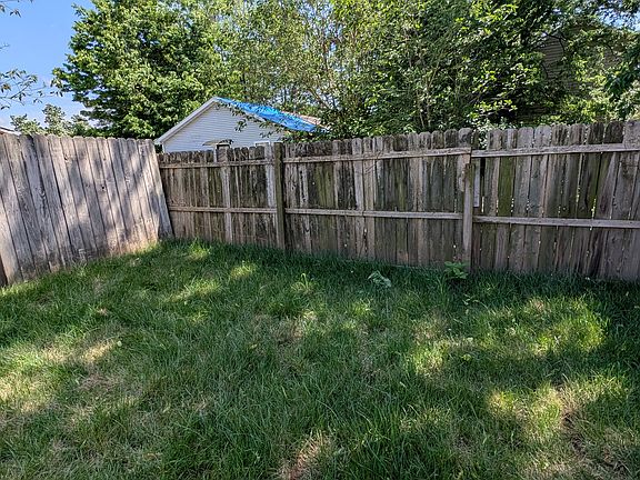 Fenced-in yard with mature trees providing shade and privacy_your own green retreat right at home.