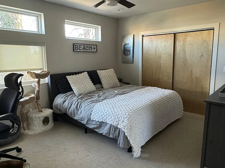 Primary bedroom 2, shown with king bed. Large closet. Three windows.
