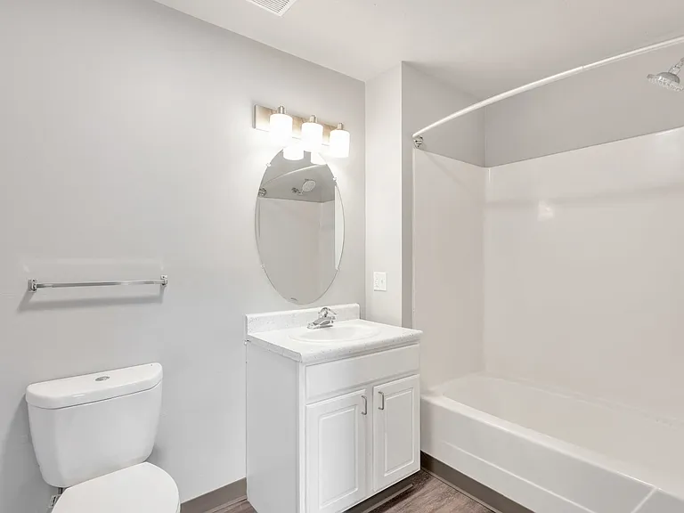 Comfortable bathrooms feature a full tub and shower combination with modern fixtures, professionally managed by Highlands Vista Group.