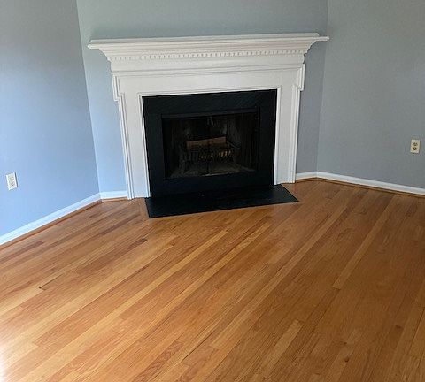 Den with wood burning fireplace