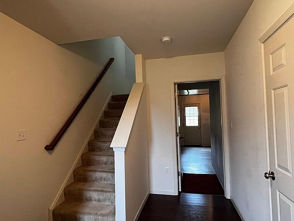 Looking into storage area and stairs to second floor