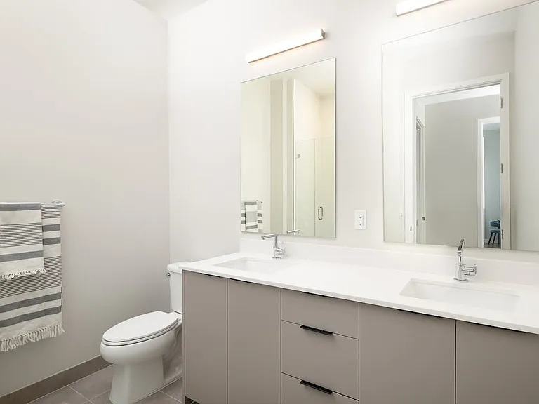Upgrade Collection II primary bath with double-sink vanity, white quartz countertops, and standing shower