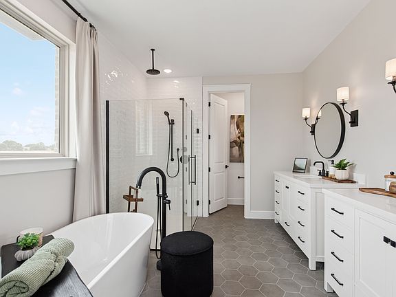 Primary bath with freestanding vanity and hexagonal tile