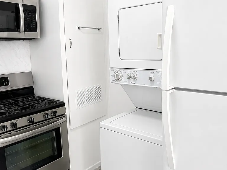 Convenient in-unit laundry setup located near the kitchen for easy everyday use.