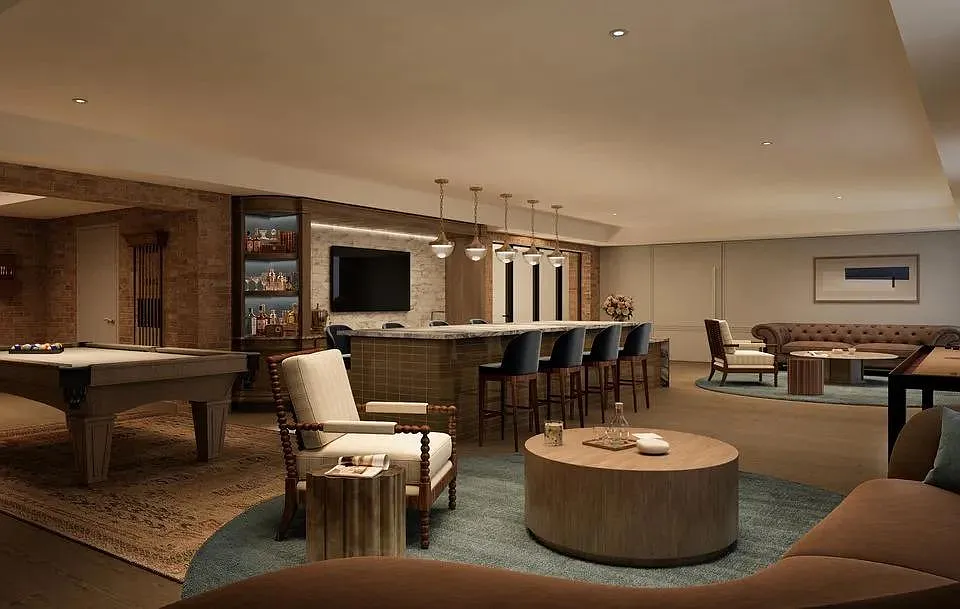 Speakeasy Lounge with billiards, lounge seating, and rich wood and brick accents, creating an intimate setting for conversation and social gatherings.