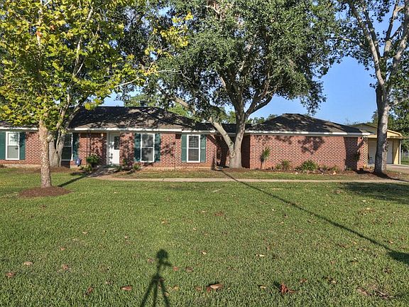 Huge front yard with several trees.