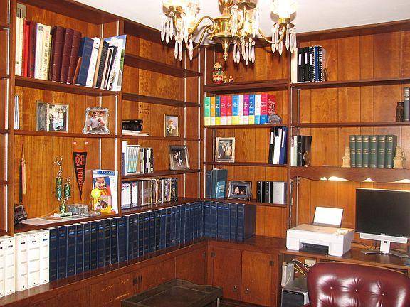 Study w/ cherry paneling, wood flooring, built in pine cabinets and shelves