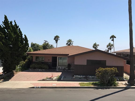 Front of property showing driveway, garage, and on-street parking