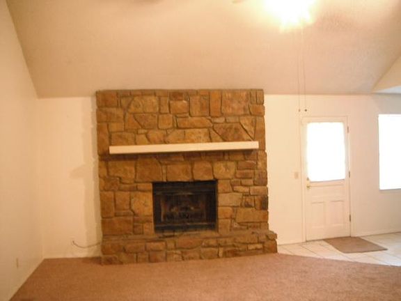 fireplace, carpet has been replaced with vinyl