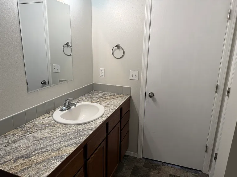 Primary bathroom, featuring a large linen closet to the right of the door.