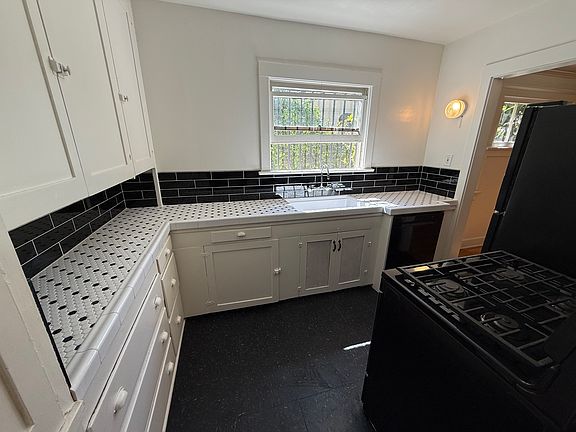 Newly updated kitchen with tiled countertop and backsplash