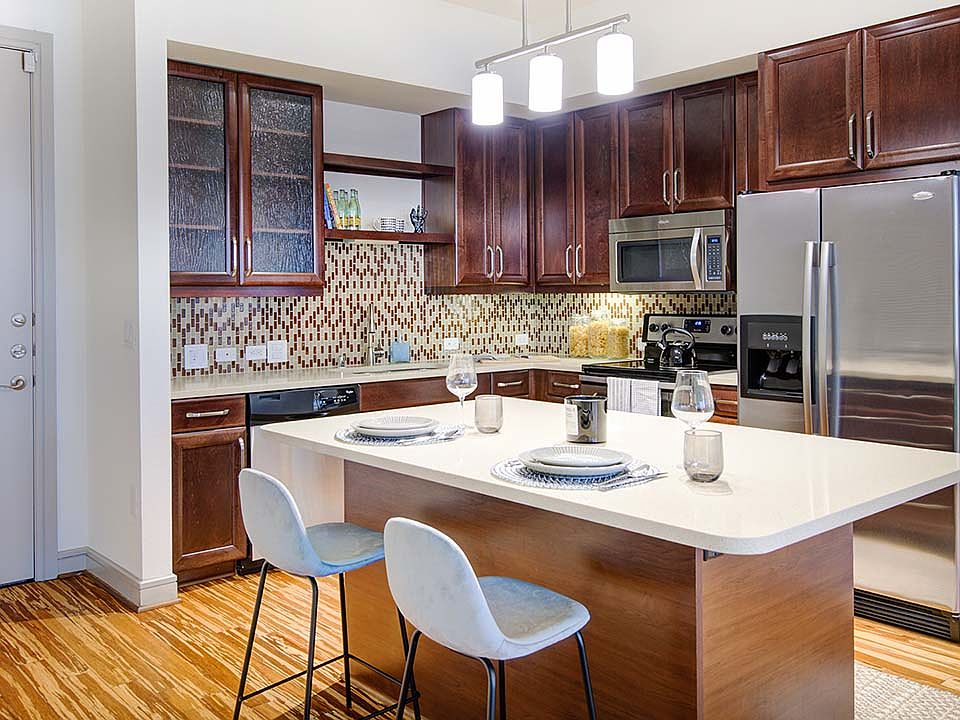 Griffis Uptown apartment kitchen with quartz countertops and stainless steel appliances.