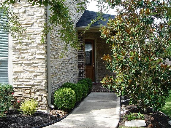 Landscaped front yard leading to the covered front porch.
