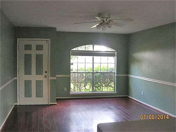 Enter the front door into the Formal Living Room which is complimented by a chair rail and laminate 