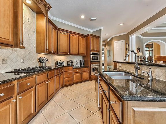 Gourmet island kitchen boasts granite  counter tops, stainless steel appliances and desirable gas range.