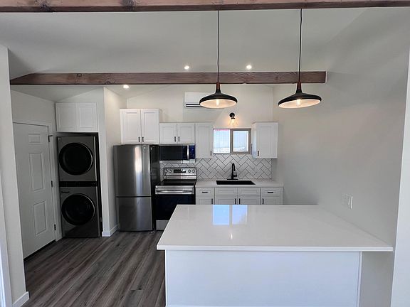 Kitchen and Laundry center with peninsula which can be used as dining area