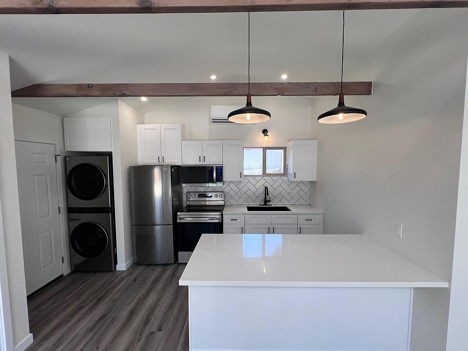 Kitchen and Laundry center with peninsula which can be used as dining area