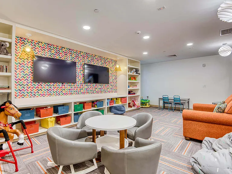 The children's recreation room is equipped with toys, large-screen TVs and plush lounge furniture