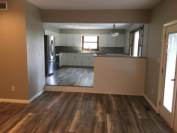 Large kitchen, photo taken while standing in the family room. Patio doors on the right opening onto the concrete patio.