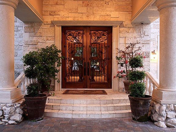 A creative design of coral, stone and stucco grace this elegant home. 