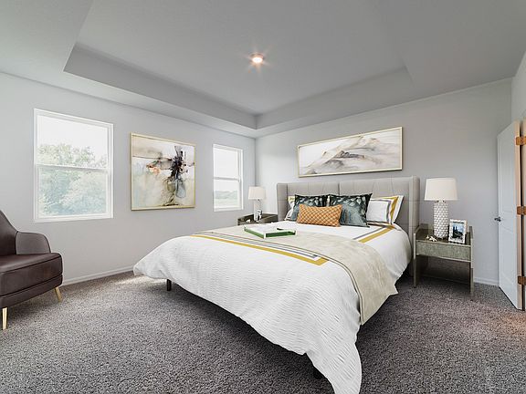 Elegant tray ceilings in the master bedroom.