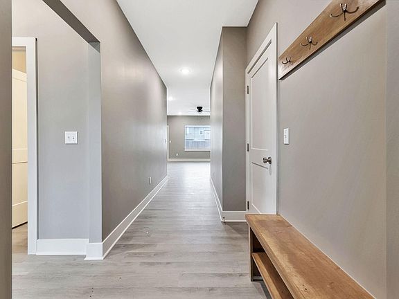Entryway with built in bench and coat rack