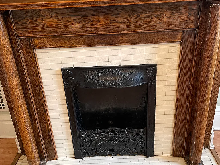 Original decorative fireplace and mantel in the bedroom