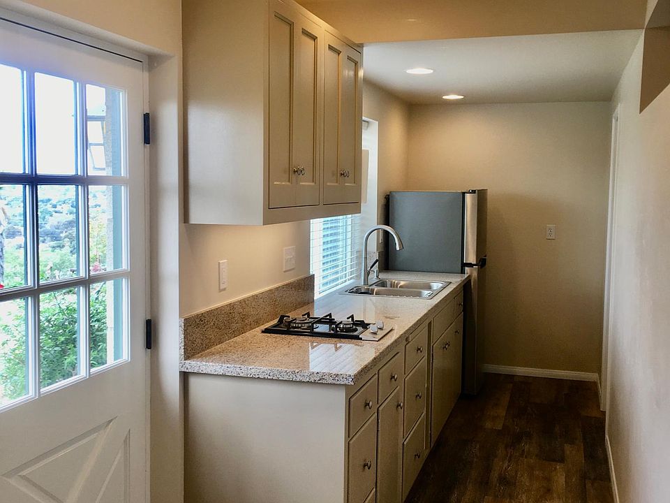 Entry door, looking into Galley Kitchen. At the end of the hall, to the right is the Bathroom and Laundry.
