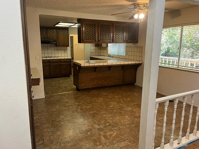 Peninsula breakfast bar and dinette space. In the background, there is a laundry room and a half bathroom.