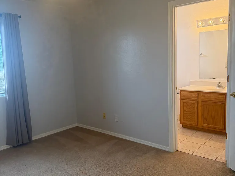Large Master Bedroom and en suite facing East. Floor-length sun-blocking drapes make a comfortable living space. All bedroom Windows have sun screens for additional comfort.