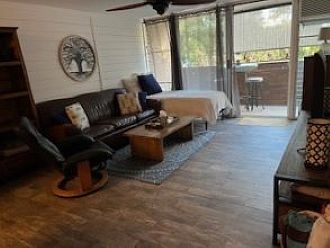 living room with twin bed and balcony