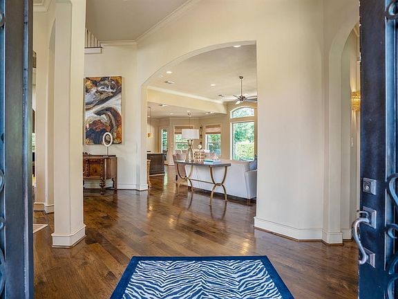 Impressive double wrought iron and glass doors lead into the foyer of the magnificent home.