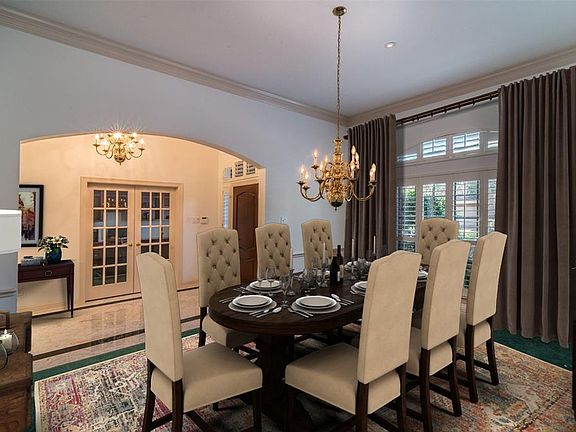 Dining room has been digitally staged for furniture placement. Pantation shutters. Attractive arched doorway. Crown Molding. This home was built by Reed Custom Homes, one of Bay Oaks original home builders.