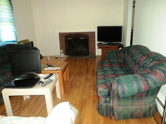 Living room with Fireplace and Hardwood
        Floors