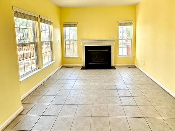 Family room with a gas fireplace open to the kitchen.
