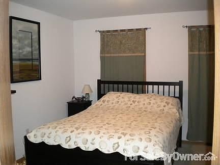 Bedroom 2 : carpeted flooring, white walls; (2 large vertical dressers & queen size bed fit)