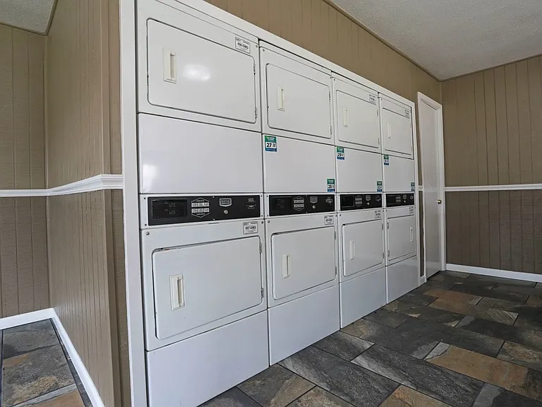 On-site laundry room with multiple washers and dryers for resident convenience.