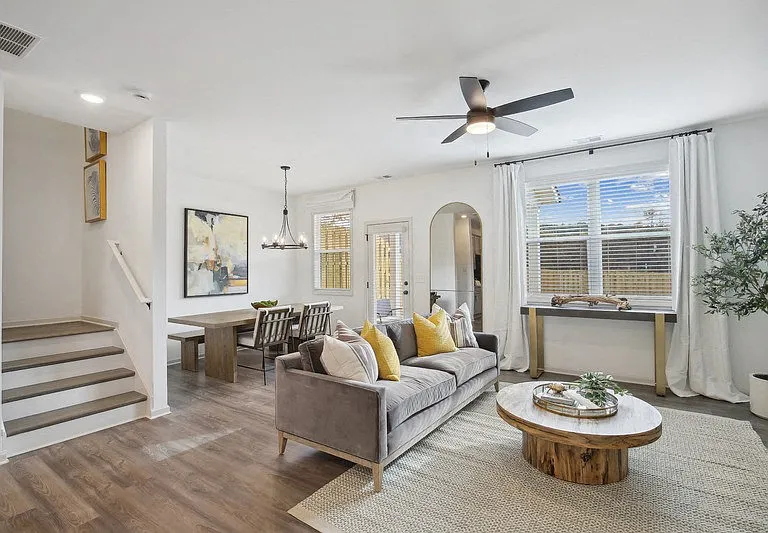Spacious living area with easy access to the stairwell and upper levels.