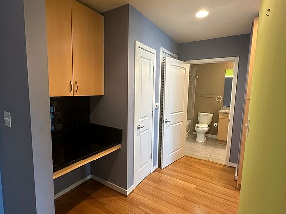 Small desk and closet next to it