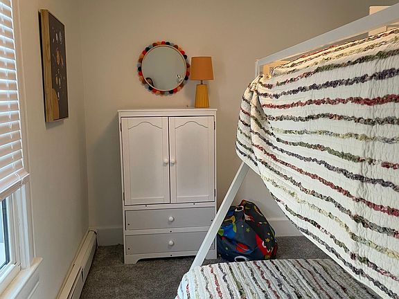 3rd upstairs bedroom with a set of bunks, twin over full and a small armoire.