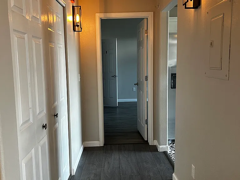 Hallway leads to master bed and kitchen to the right.