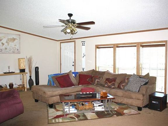 Opposite view of the spacious living room. There is new carpet and fresh paint throughout.