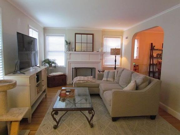 LIVING ROOM - HARDWOOD FLOORS - WINDOWS HAVE PLANTATION SHUTTERS