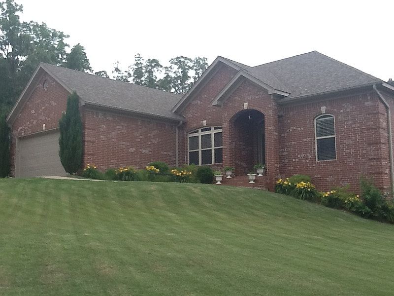 Front View, guttering with flower beds and fenced yard, sprinkler system