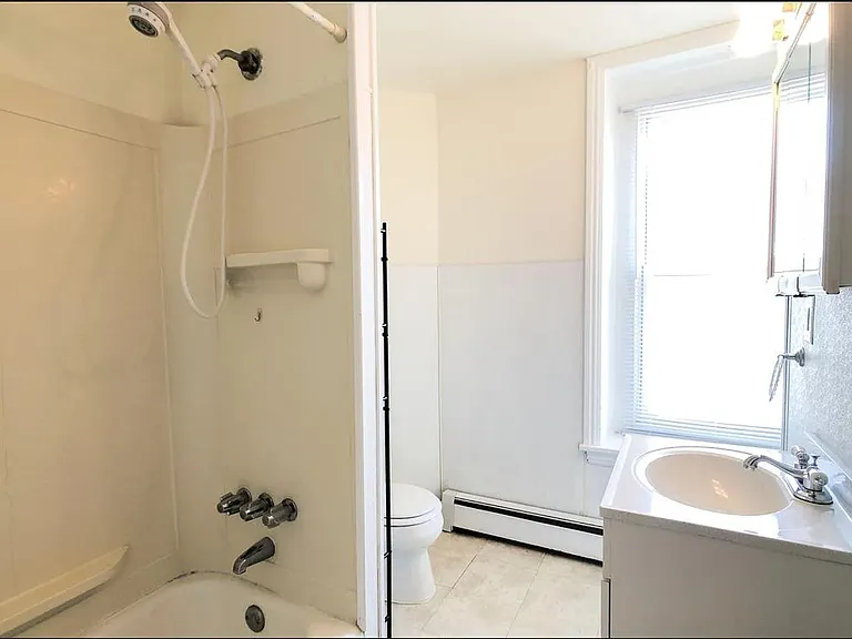 The bathroom has been refreshed with a tile shower, new floors, an upgraded vanity and mirror, and a new window to fill the space with natural light. Updated listing photos coming soon!