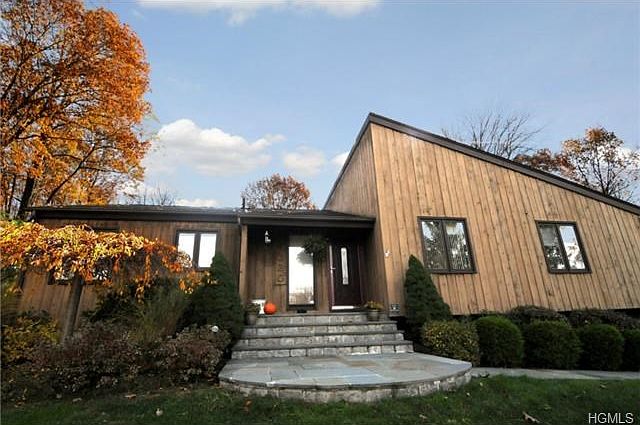 Contemporary home with custom stone walls, walkway and steps.
