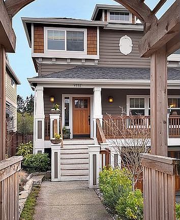 Walkway to front door is lined with native vegetation.