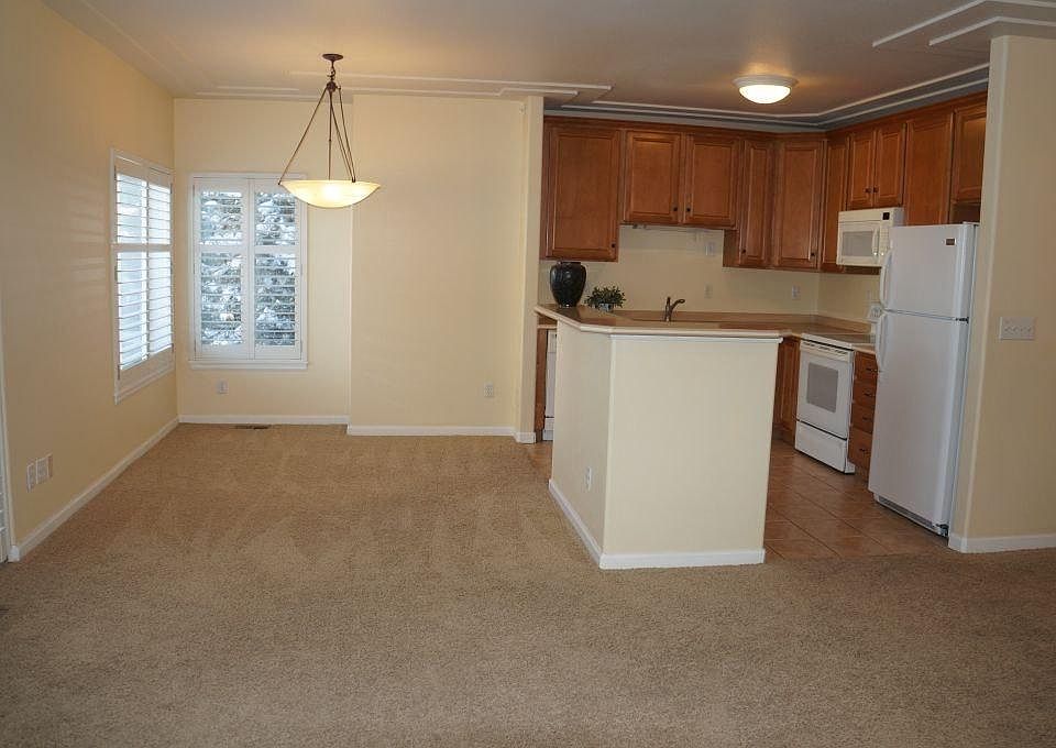 Dining room and kitchen with custom window treatments