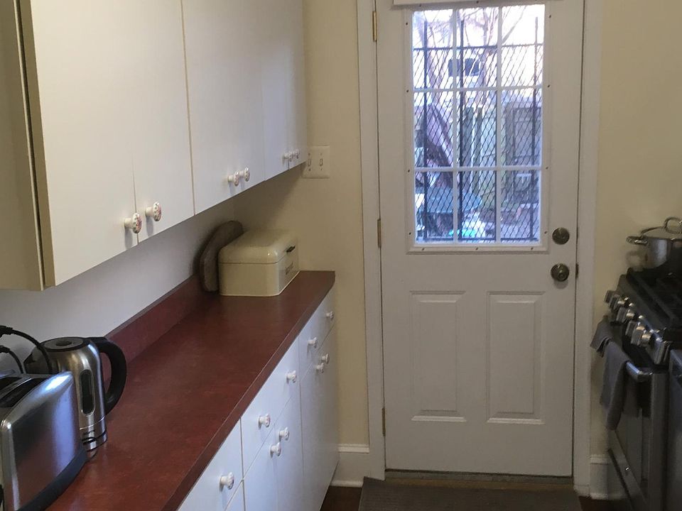 one side of kitchen with rear entrance to backyard