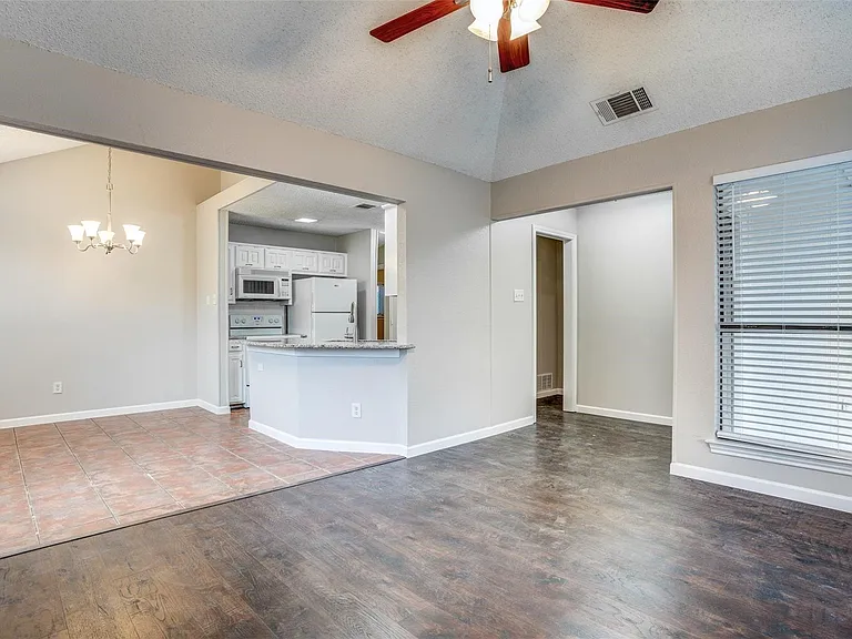 View of kitchen, entry and living & dining areas.